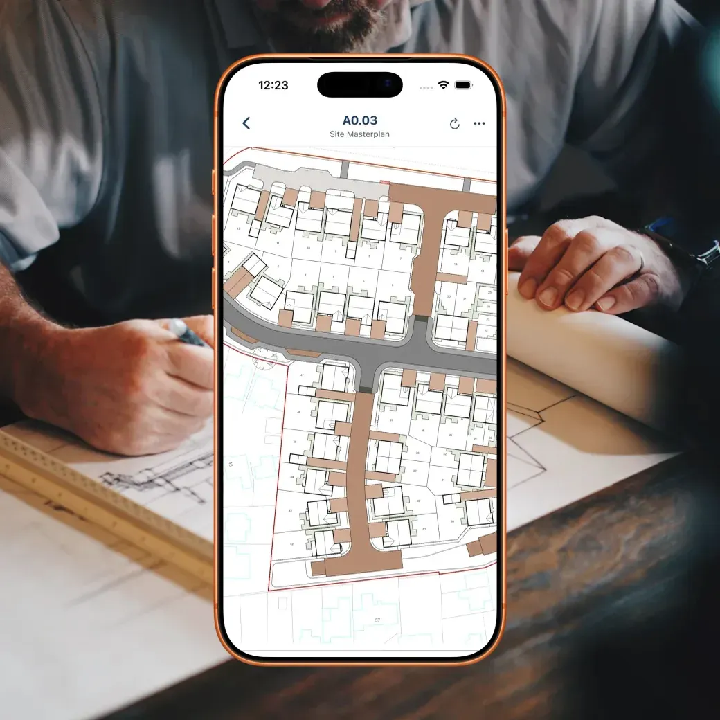 BuildersAI plans viewer on a phone over hands working on an architectural blueprint