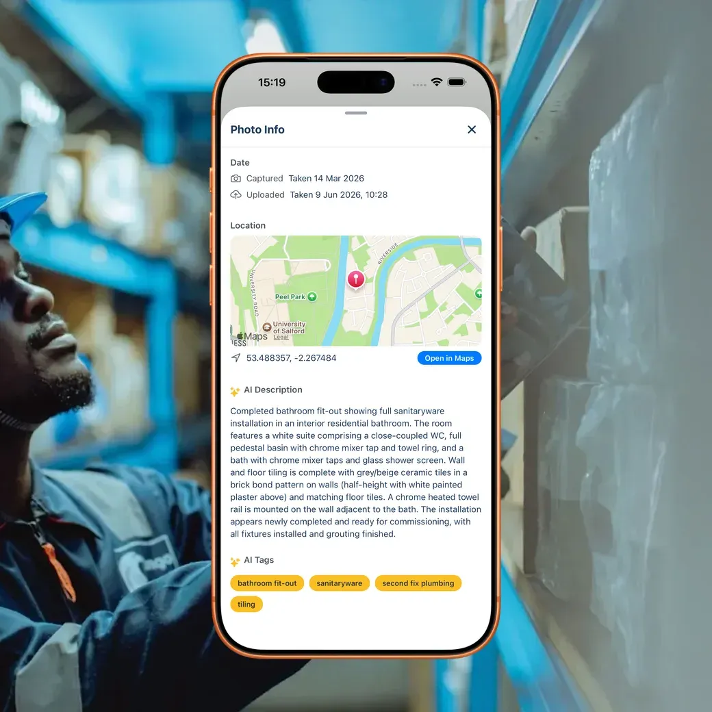 BuildersAI compliance view on a phone over a hard-hat worker checking stock against paperwork