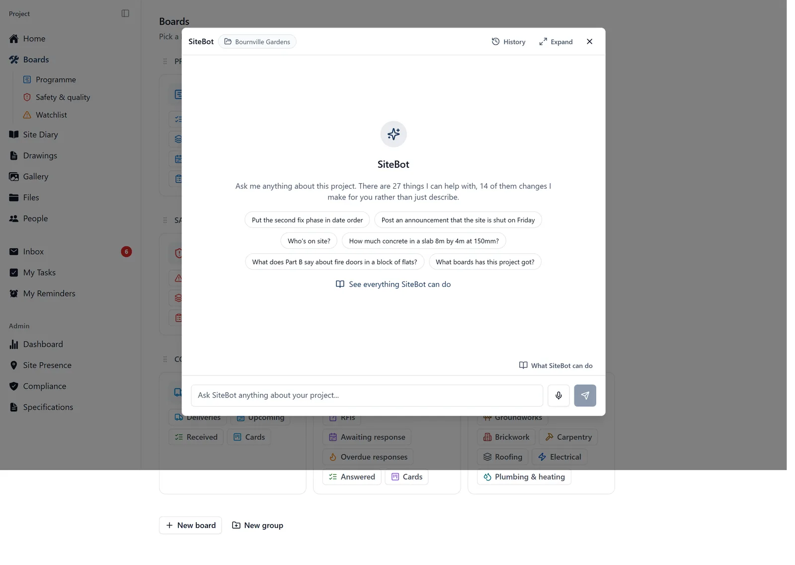 The SiteBot chat panel open over a project's Boards page, with the project name in a pill beside the SiteBot title, six suggested questions, a link reading See everything SiteBot can do, and a message box with a microphone button and a What SiteBot can do link above it.